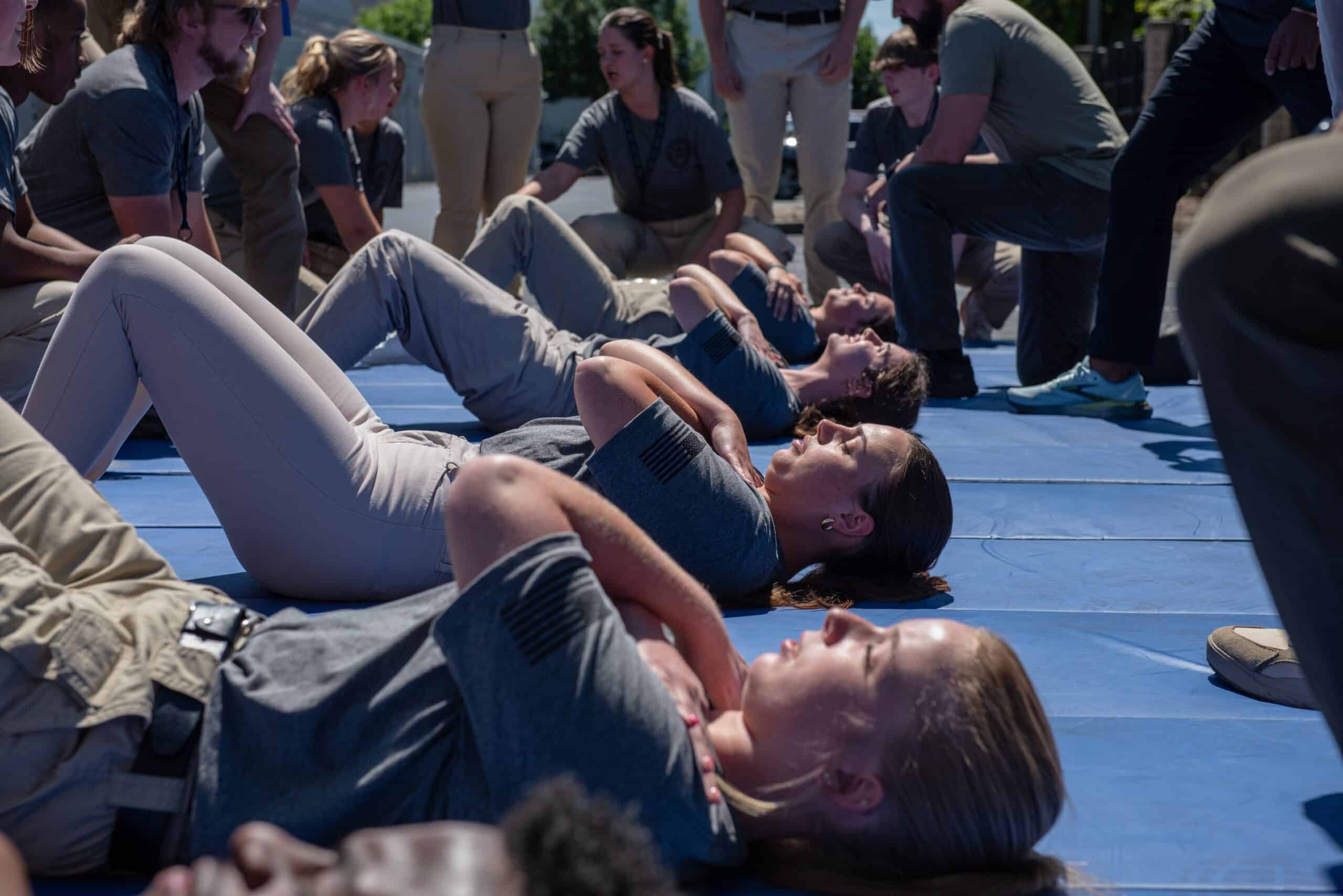 FBI Future Agents in Training do sit-ups as part of the FBI PFT