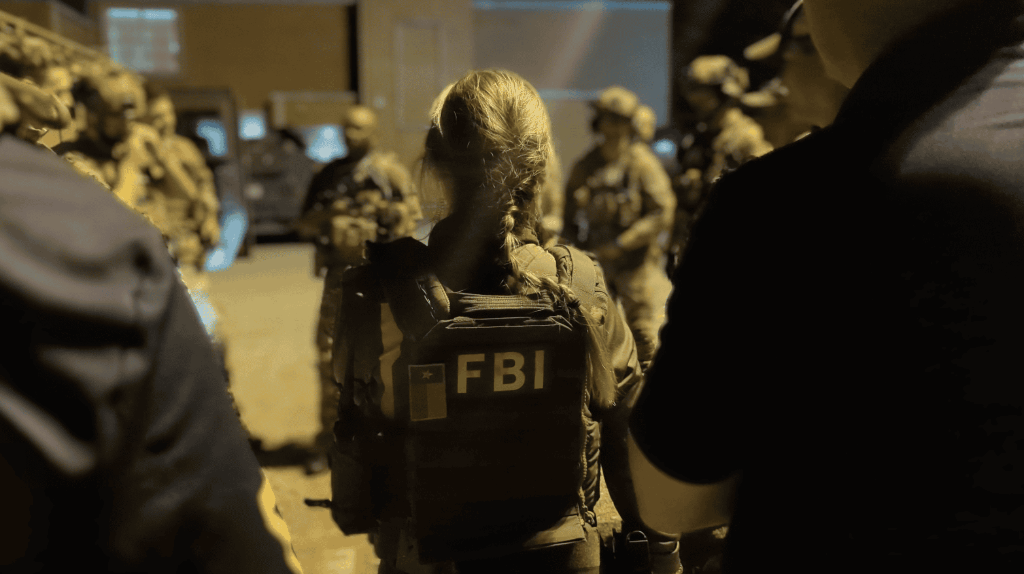 FBI personnel and SWAT operators in pre-dawn preparations.